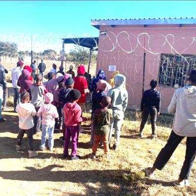 Image 2. Lots Of Children Infront Of Fence